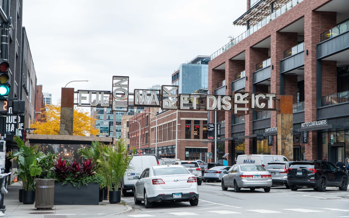 Fulton Market District sign over busy Fulton Street