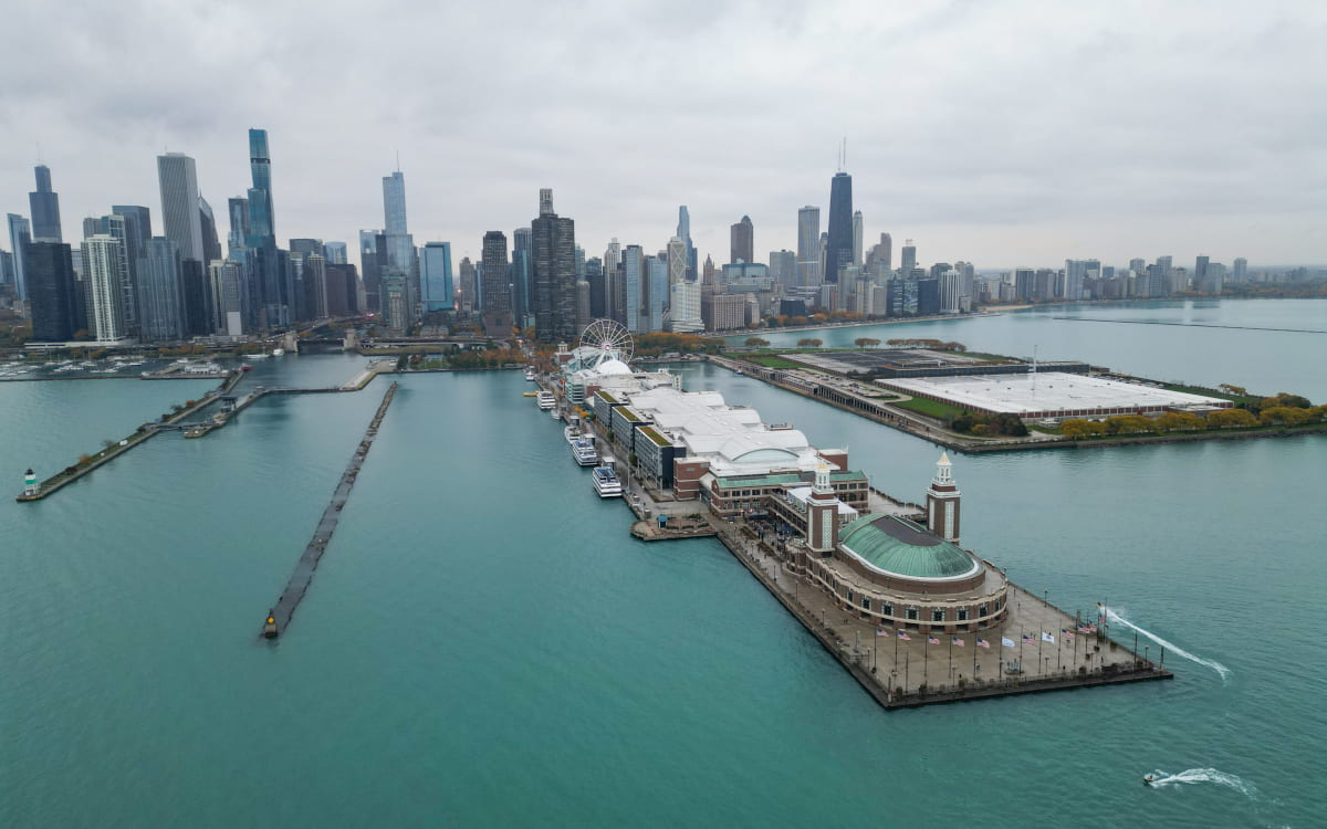 Overhead view of Lake Michigan and Navy Pier, with the skyscrapers of downtown Chicago in the background