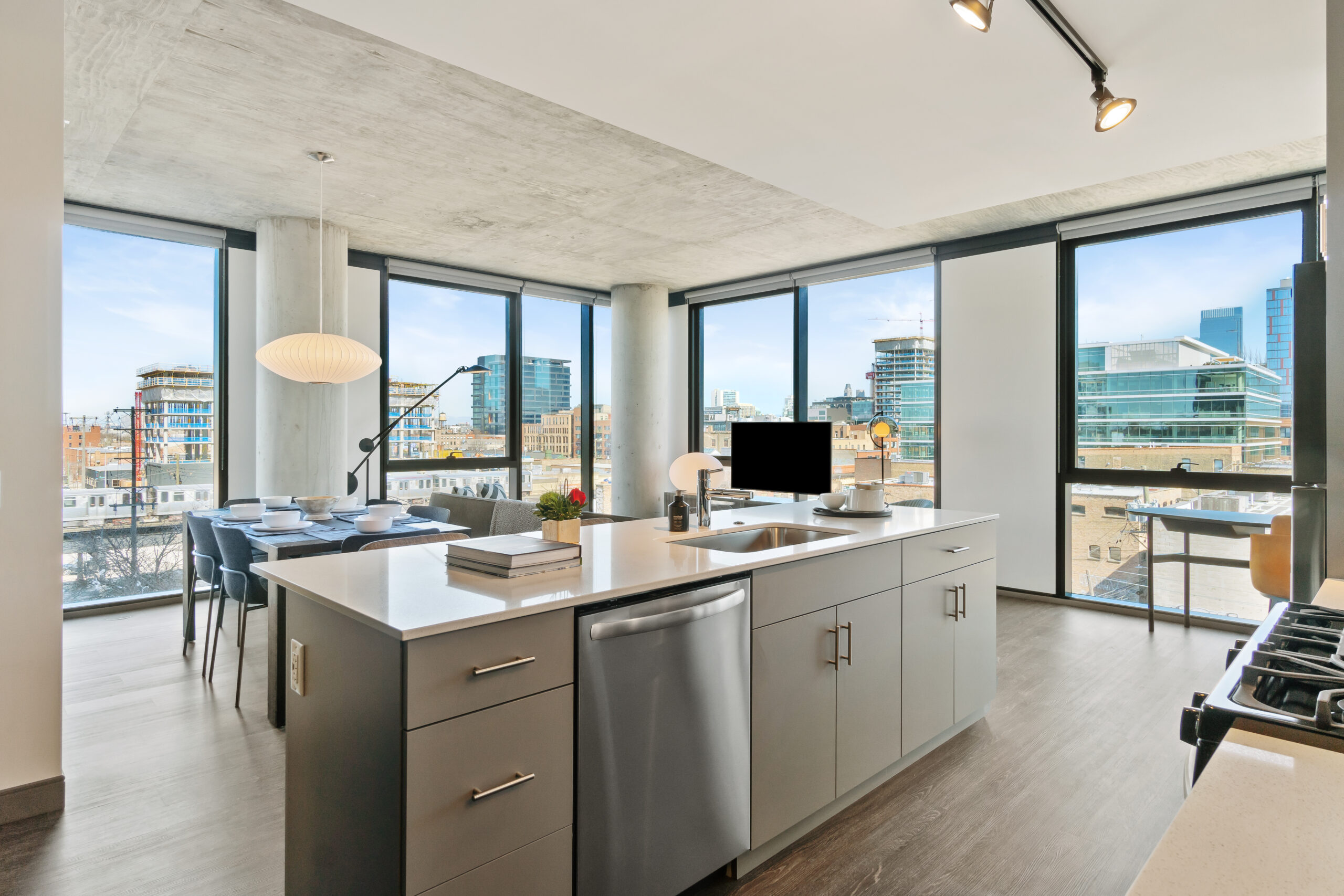 Modern kitchen and dining area with view of Chicago skyline through large windows