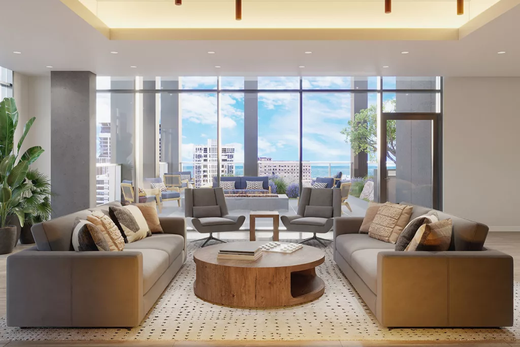 Resident lounge inside 1400 Wabash with couches in front of floor to ceiling windows.