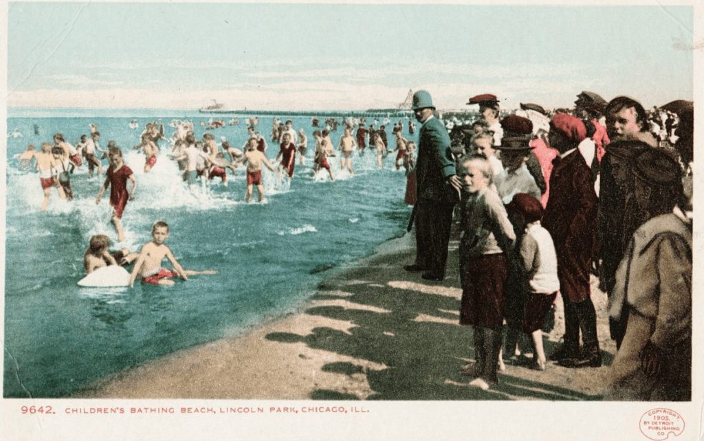 A vintage postcard showing off children bathing in Lake Michigan
