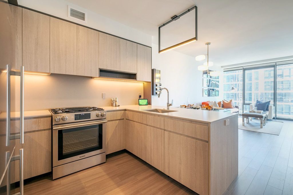 A kitchen and open living area at NEMA apartments in Chicago