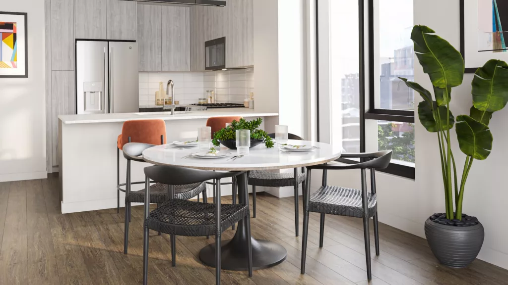 An image of the interior of a luxury apartment at One Six Six in downtown Chicago. Light streams in from the windows and into the modern kitchen in this beautiful apartment.