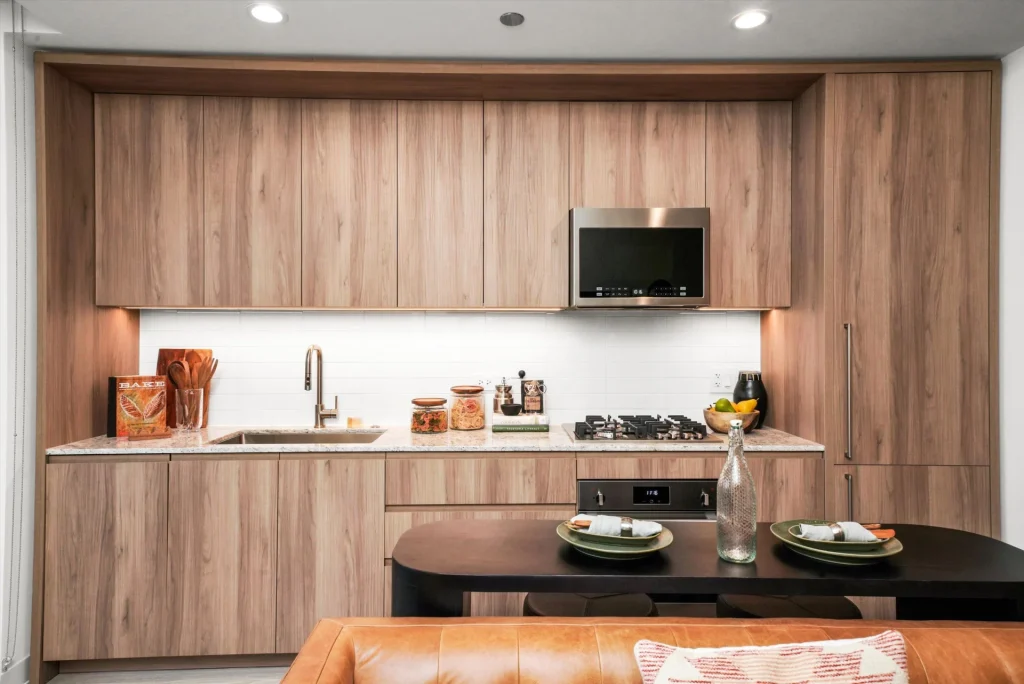 Natural wood grain cabinets inside kitchen space at Onni Fulton Market.
