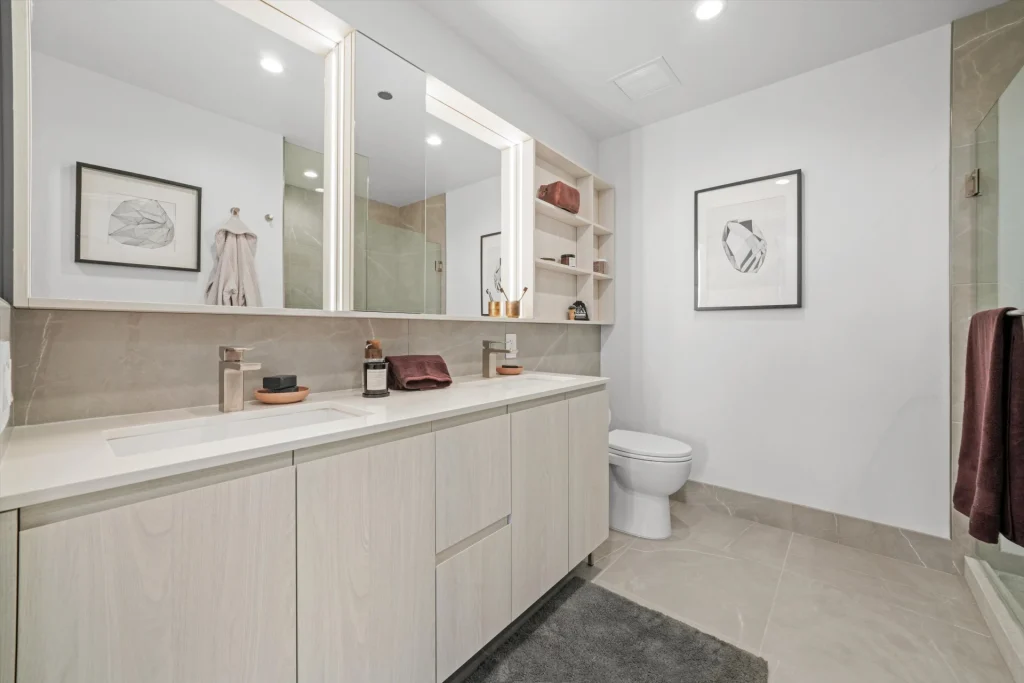 Luxury bathroom with light cabinets and double vanity.