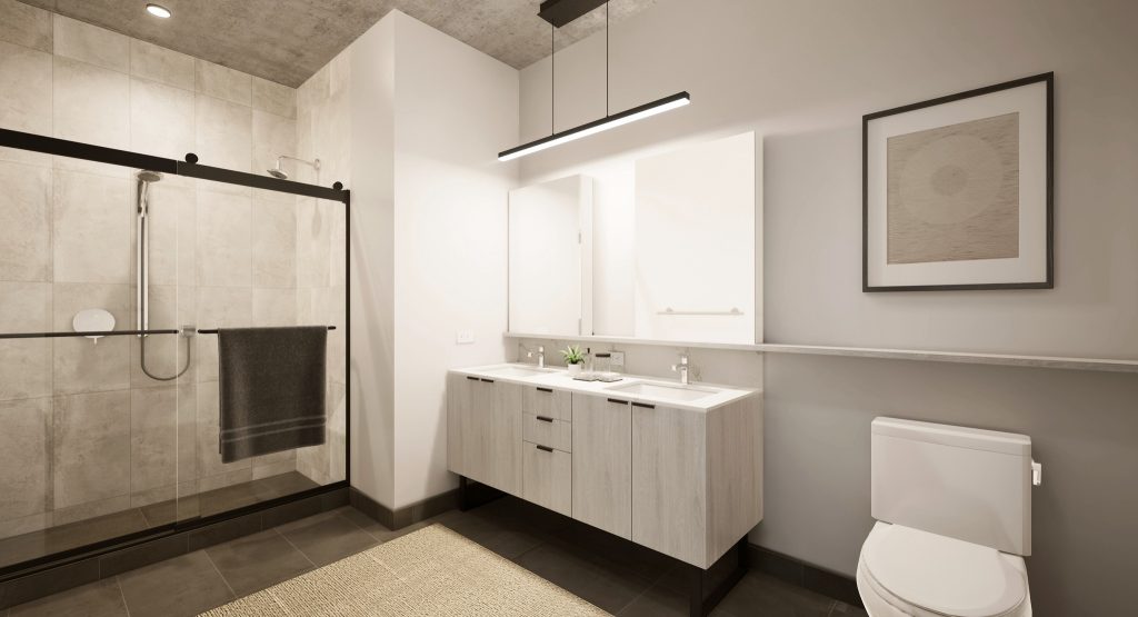 Massive bathroom with light cabinetry and bright lighting. 