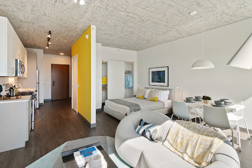 Convertible apartment at Fulbrix with yellow wall and living area.
